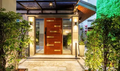 an entrance to a house with a wooden door at Penyos Service Apartment in Bangkok