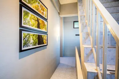 a staircase in a house with two windows at Penyos Suite in Bangkok