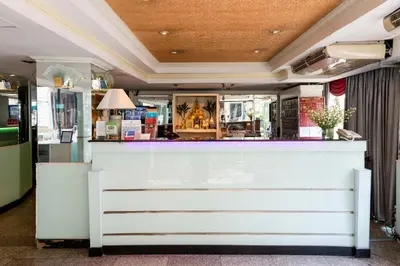a bar with a white counter in a room at The Best Bangkok House in Bangkok