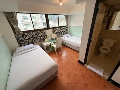 a small room with two beds and a toilet at The Best Bangkok House in Bangkok