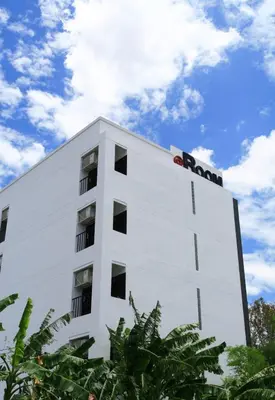 a white building with a ron sign on it at @Room Apartment in Bangkok