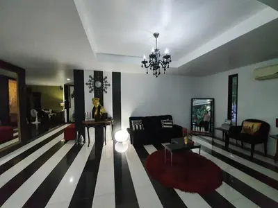 a living room with a black and white striped floor at @Room Apartment in Bangkok