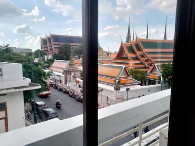 a view from a window of a street and buildings at Chetuphon Gate in Bangkok