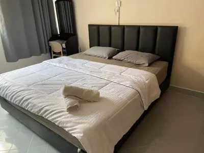 a large bed with a black headboard and white sheets at Dailyroom C3,C4by Anna in Nonthaburi