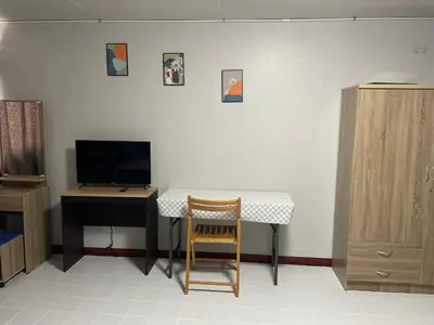 a room with a desk and a table and a chair at Dailyroom C3,C4by Anna in Nonthaburi