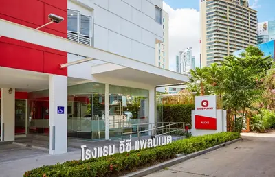 a building with a sign in front of it at Easy Planet Bangkok Asoke in Bangkok