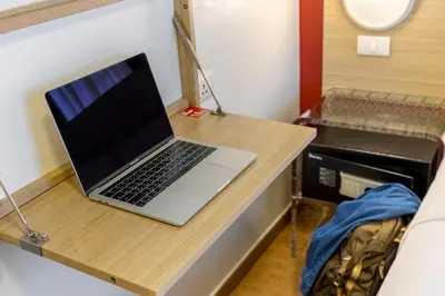 a laptop computer sitting on a desk in a room at Easy Planet Bangkok Asoke in Bangkok
