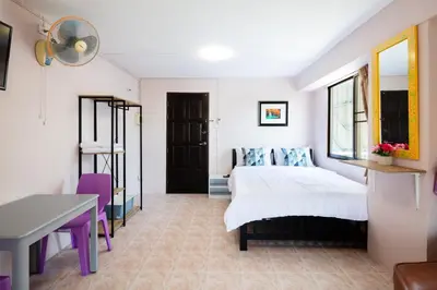 a bedroom with a bed and a desk at Penyos Mansion (Long Stay) in Bangkok