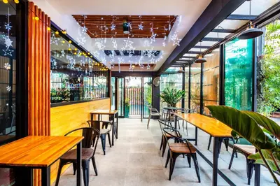 a restaurant with wooden tables and chairs at Penyos Mansion (Long Stay) in Bangkok