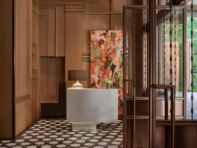 a lobby with a large painting on the wall at Rosewood Bangkok in Bangkok