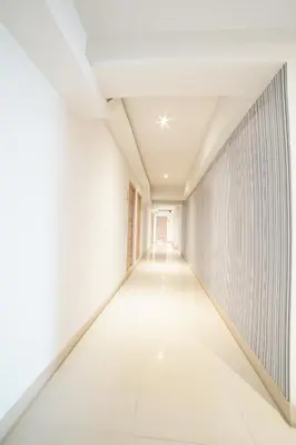 an empty corridor in an empty room with white walls and ceilings at 48 Ville Donmuang Airport in Bangkok