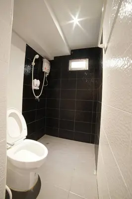 a small bathroom with a toilet and a shower at 48 Ville Donmuang Airport in Bangkok
