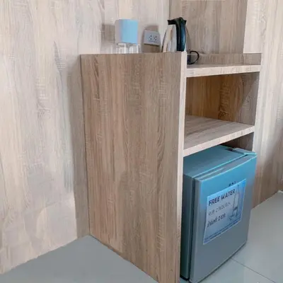 a wooden shelf with a blue box in a room at 48 Ville Donmuang Airport in Bangkok