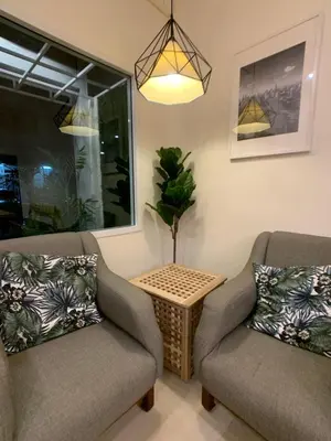 a living room with two chairs and a table at House 116 in Bangkok