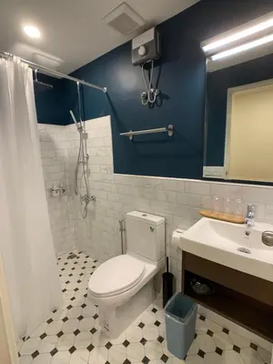 a bathroom with a white toilet and a sink at House 116 in Bangkok