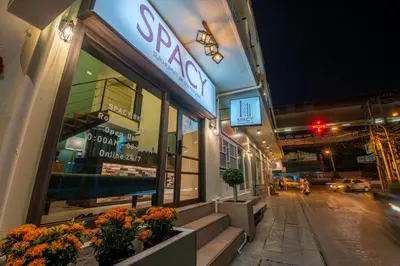 a store front of a building with flowers in the window at Spacy BKK in Bangkok