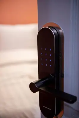 a close up of a pay phone on a door at Spacy BKK in Bangkok