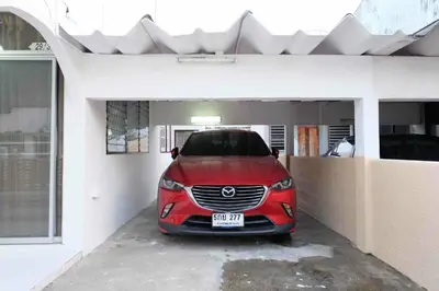 a red car parked inside of a garage at Chatuchak Art & Nature House ( 3-6 pers.) in Bangkok