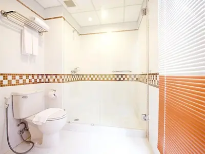a bathroom with a toilet and a shower at The Ecotel Bangkok in Bangkok