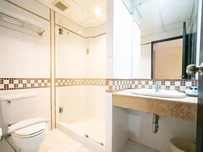 a bathroom with a toilet and a sink at The Ecotel Bangkok in Bangkok