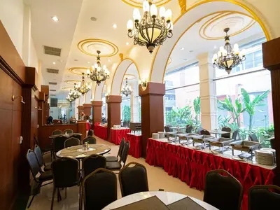 a dining room with tables and chairs and chandeliers at The Ecotel Bangkok in Bangkok