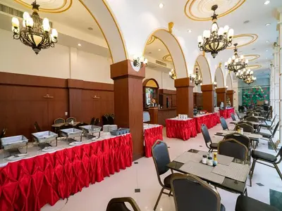a dining room with tables and chairs and chandeliers at The Ecotel Bangkok in Bangkok