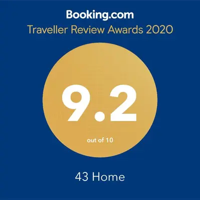 a sign that reads traveler review awards with a yellow circle at 43 Home in Bangkok Noi