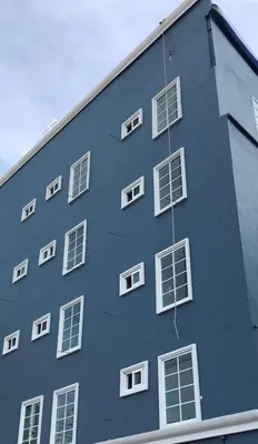 a blue building with white windows on the side of it at 43 Home in Bangkok Noi