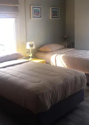 a hotel room with two beds and a window at 43 Home in Bangkok Noi