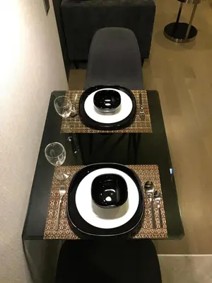 a table with two plates and glasses on it at Luxurious & Romantic in the Heart of BKK. MRT/BTS! in Bangkok