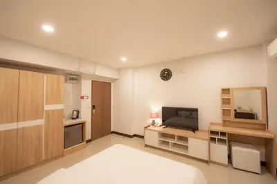 a bedroom with a bed and a television in it at U Sabai Hotel Bangkok in Bangkok