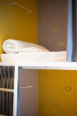 a bed in a room with a bunk bed at Boxpackers Hostel Phranakorn in Bangkok