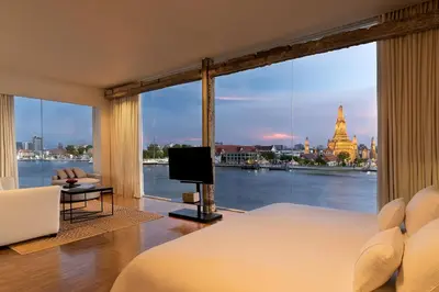 a bedroom with a large window with a view at Sala Rattanakosin Bangkok in Bangkok