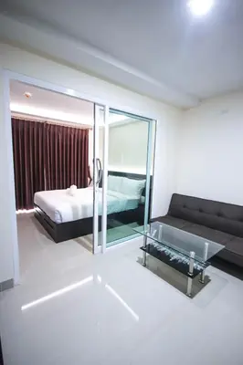 a hotel room with a bed and a mirror at The Cosy River in Bangkok
