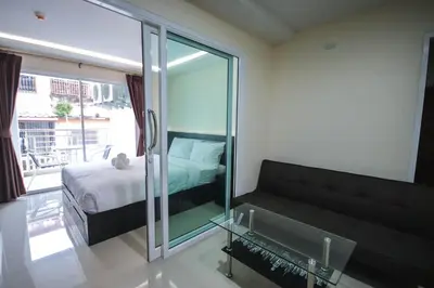 a living room with a couch and a bed at The Cosy River in Bangkok