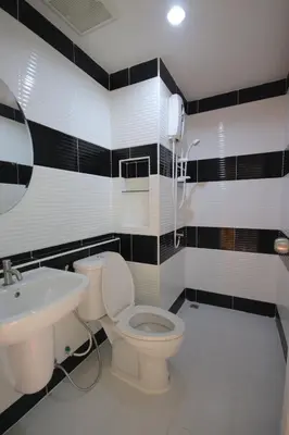 a bathroom with a toilet and a sink at The Cosy River in Bangkok