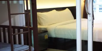 a bedroom with a bed and a ladder with a bed at The Cosy River in Bangkok