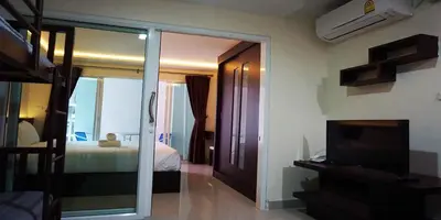 a bedroom with a bed and a sliding glass door at The Cosy River in Bangkok