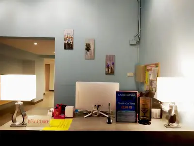 an office with a desk with a computer and two lamps at Sleep with Me Bangkok - BTS Phra Khanong in Bangkok