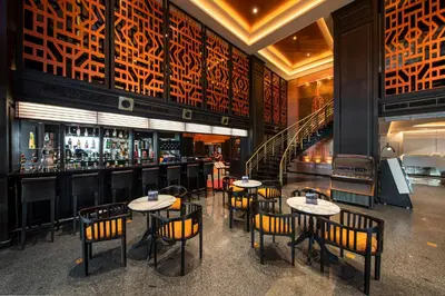 a restaurant with tables and chairs and a bar at Manhattan Hotel Bangkok in Bangkok