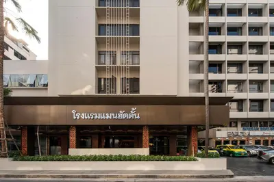 a building with a sign for a hotel at Manhattan Hotel Bangkok in Bangkok