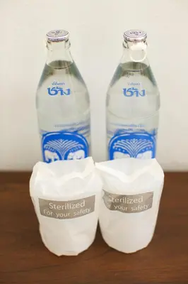 two bottles of bottled water sitting on a table at Chang Siam Inn in Bangkok