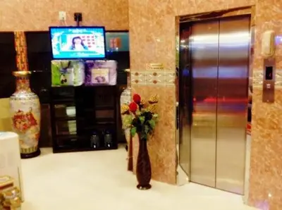a lobby with a vase with a flower in it at Penang Palace in Bangkok