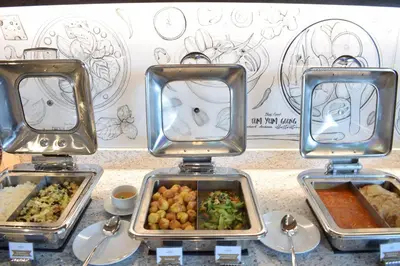 three food trays with different types of food on a table at Aspira One Sutthisan in Bangkok