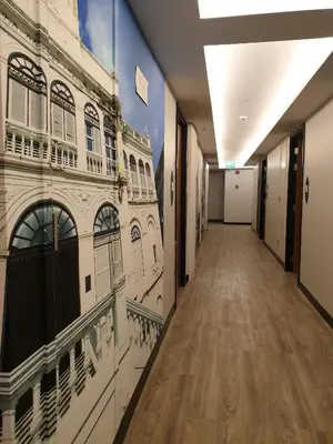 a hallway with a mural of a building at Aspira One Sutthisan in Bangkok