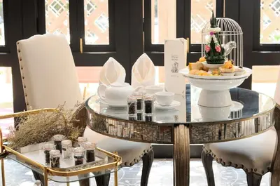 a glass table with a bowl of food on it at Hua Chang Heritage Hotel in Bangkok