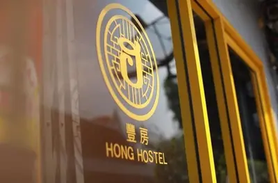 a sign on the door of a home hustle bus at Hong hostel in Bangkok