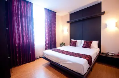 a bedroom with a large bed with a large window at Siam Paradise Entertainment Complex in Bangkok