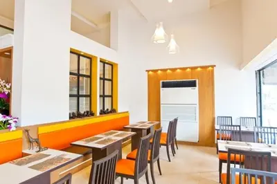 a dining room with tables and chairs in a restaurant at Siam Paradise Entertainment Complex in Bangkok