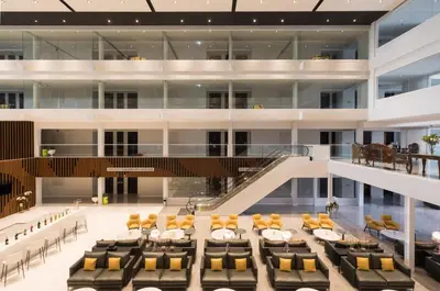 a dining room in a building with chairs and tables at S Ram Leisure Hotel in Bangkok